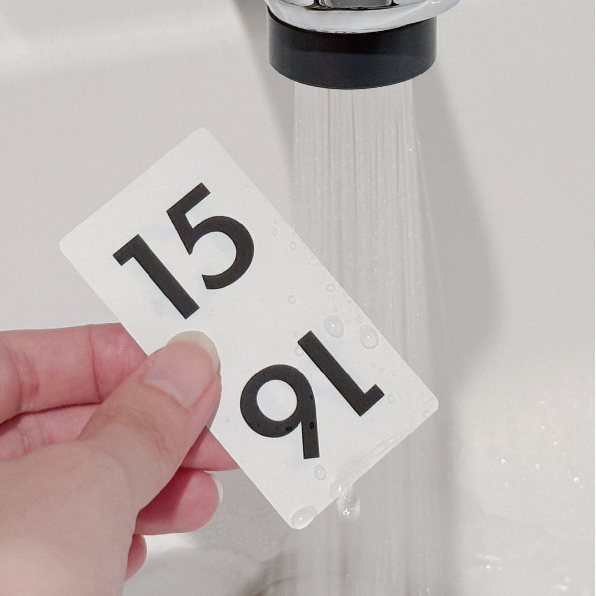 Carl Panel Calendar date panel being rinsed under a tap