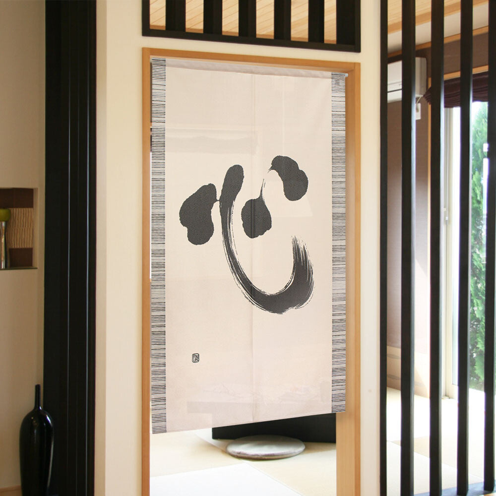 Cream noren curtain with black brushstroke character in light wood frame