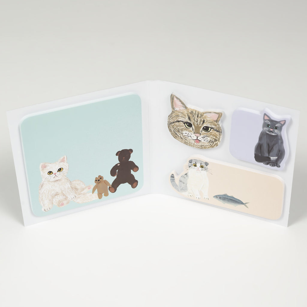 Open folding book sticky notes showing mint square and three shaped cat notes
