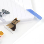 Blue bookmark tab marking a page in a notebook through the clear plastic board
