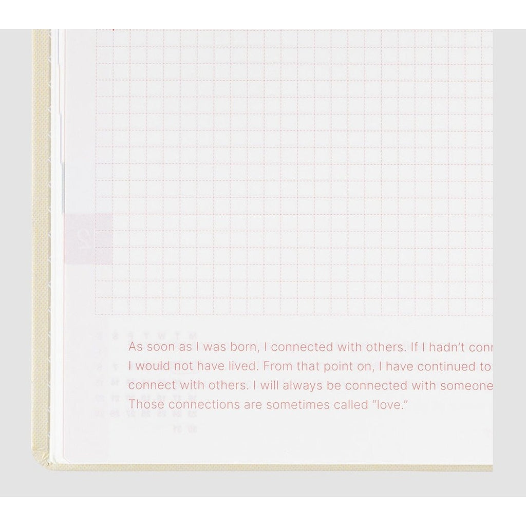 Hobonichi Techo 2024 open page with red dashed grid and inspirational quote text block
