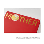 Close-up of red woven fabric cover with bold gold MOTHER lettering and globe graphic