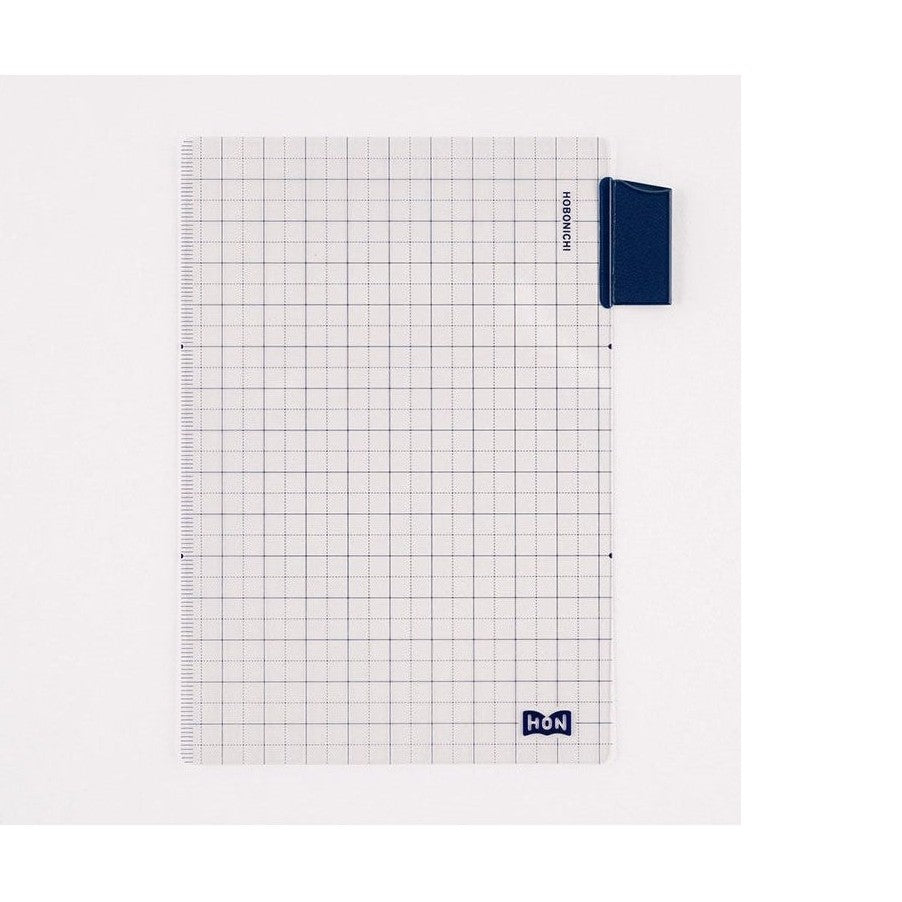 Close-up of transparent grid insert page protector with HOBONICHI clip and ruler