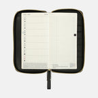 Hobonichi Techo Weeks Notte cover holding July 2024 planner with wrist strap