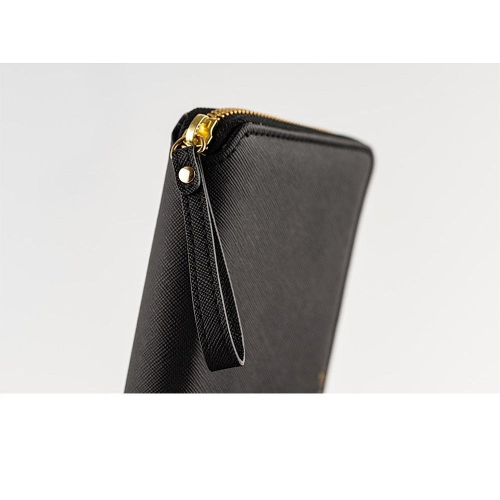 Angled black Hobonichi Techo Weeks Notte cover with gold zipper and rivet