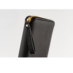 Angled black Hobonichi Techo Weeks Notte cover with gold zipper and rivet
