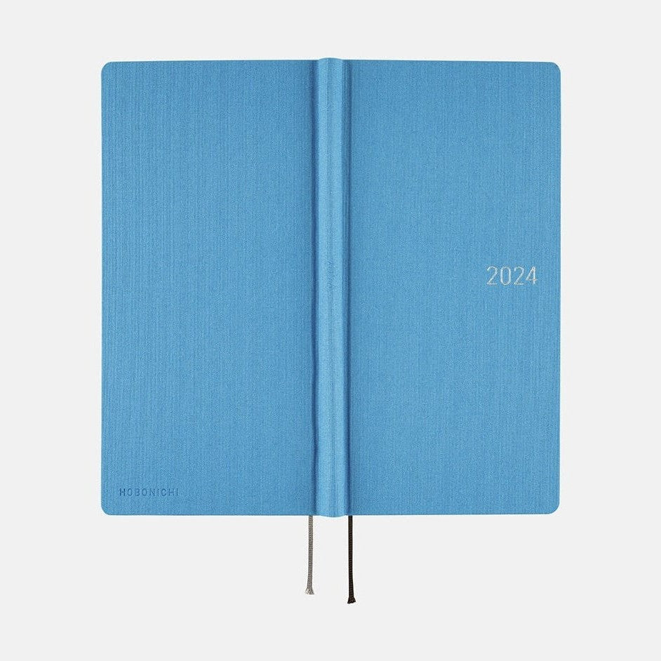 Open Hobonichi Techo 2024 Weeks Celeste Blue showing silver printed cover text and ribbon bookmark