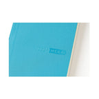 Side view of aqua blue Hobonichi Techo 2024 MEGA with embossed title and page edge