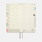 Open Hobonichi Techo 2024 Weeks planner with July grid and comic art spine