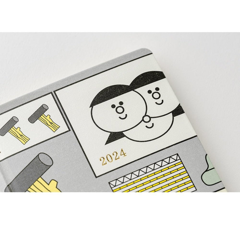 Hobonichi Techo 2024 front cover corner featuring gold foil year and cartoon faces