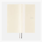 Open Hobonichi Techo 2024 ivory softcover showing spine crease and ribbon bookmarks