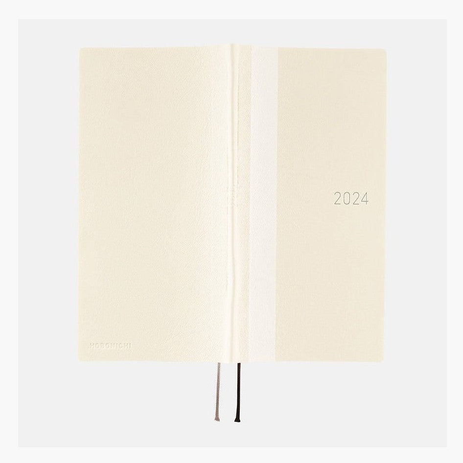 Open Hobonichi Techo 2024 ivory softcover showing spine crease and ribbon bookmarks