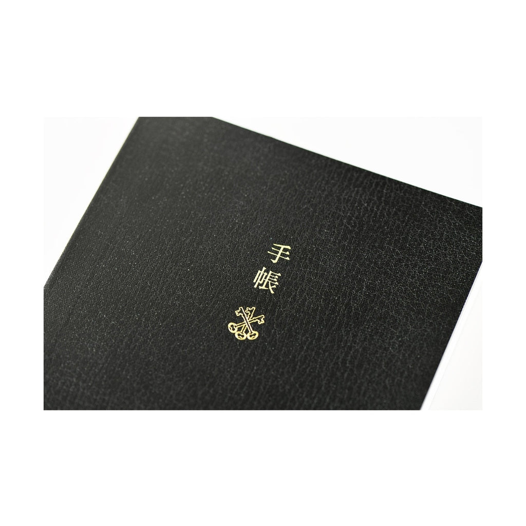 Black Hobonichi Techo 2025 front cover with gold foil 'techo' text and crossed keys emblem