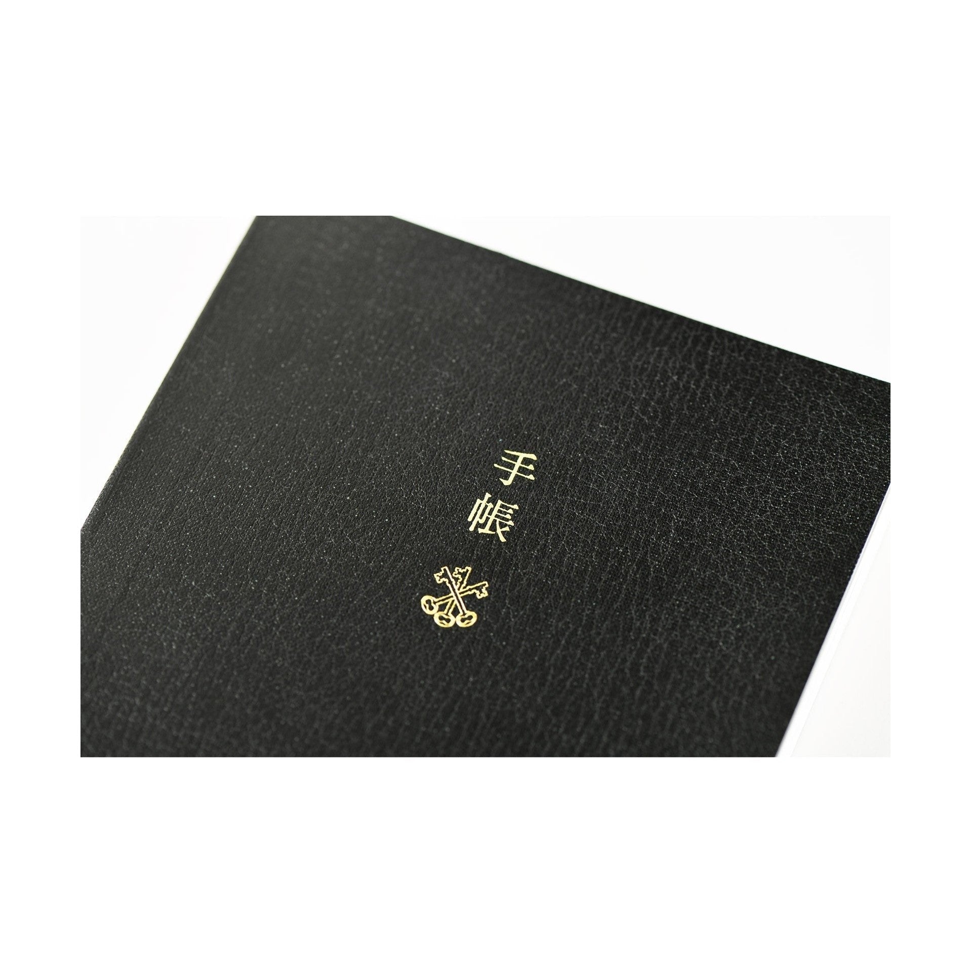 Black Hobonichi Techo 2025 front cover with gold foil 'techo' text and crossed keys emblem