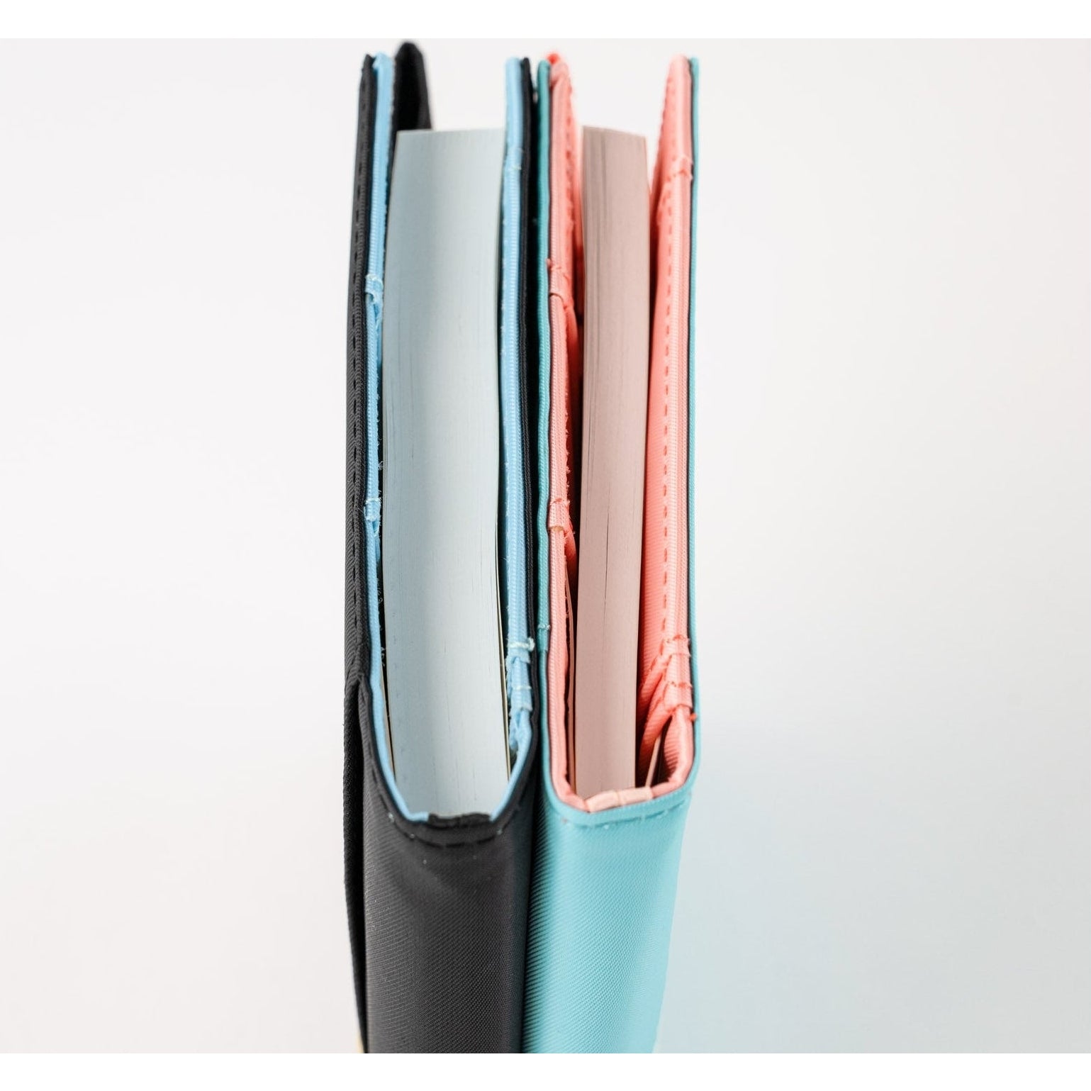 Two Hobonichi Techo 2025 A6 notebooks standing upright showing thread-stitched spines