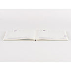 Hobonichi Techo 2025 flat lay view of daily grid pages with purple date markers