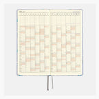 Hobonichi Techo 2025 Weeks planner showing full year calendar grid with Japanese dates and ribbon bookmark