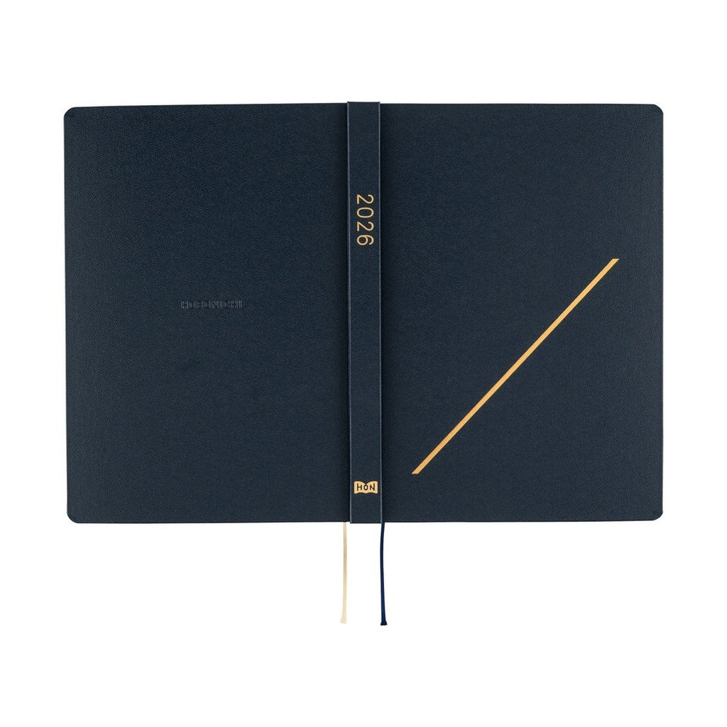 Inside covers of navy Hobonichi Techo 2026 A5 planner featuring gold foil '2026' text and HON logo