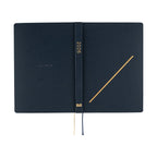 Inside covers of navy Hobonichi Techo 2026 A5 planner featuring gold foil '2026' text and HON logo
