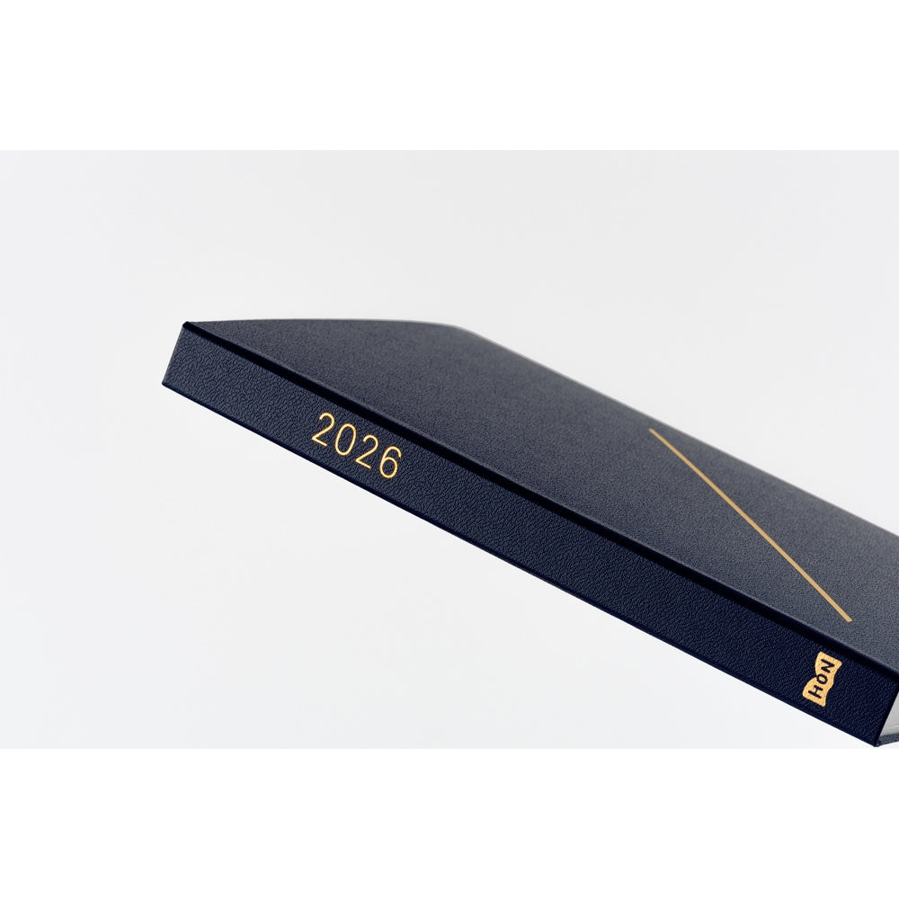Hobonichi Techo 2026 A5 Navy hardcover planner with gold foil slash design and matte cloth cover