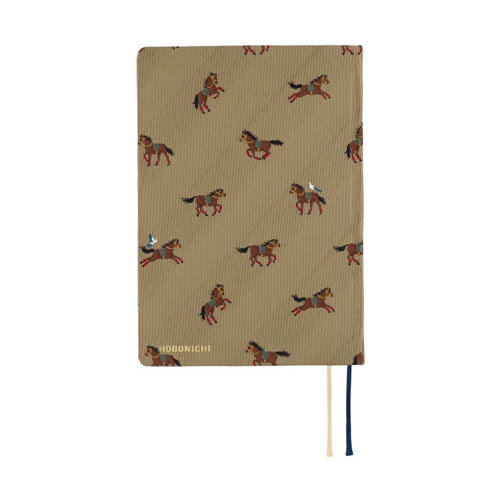 Tan woven Hobonichi 2026 A6 diary with embroidered horses and navy cream ribbons