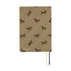 Tan woven Hobonichi 2026 A6 diary with embroidered horses and navy cream ribbons