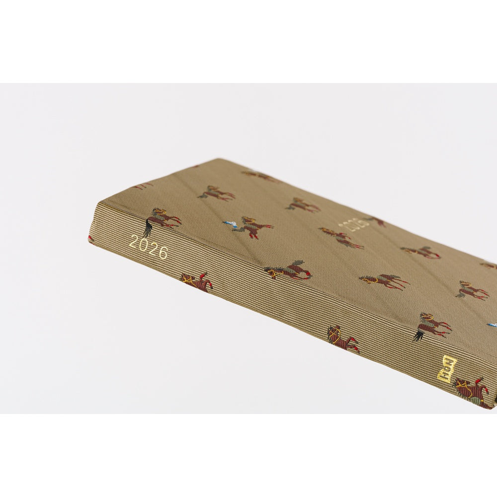 Close-up of Hobonichi 2026 A6 diary spine showing gold year print and fabric texture