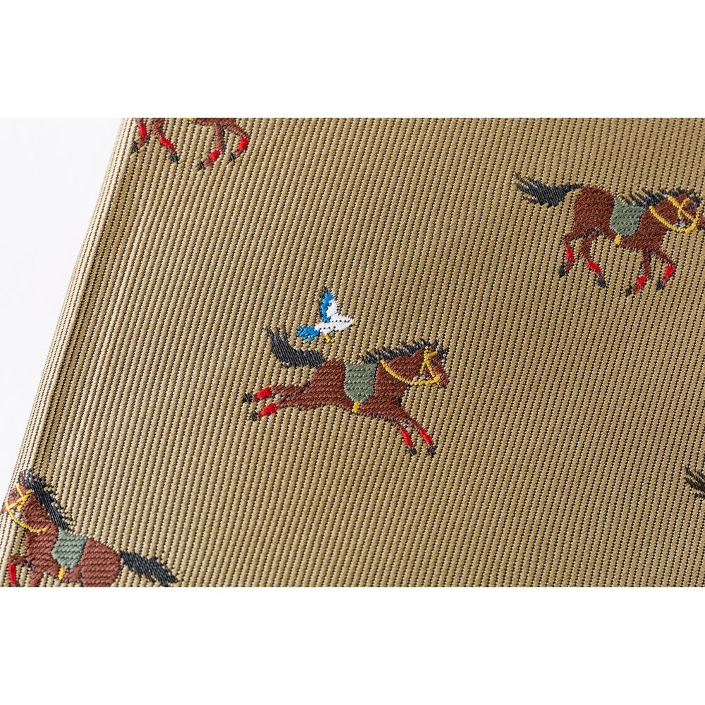 Macro shot of Hobonichi 2026 A6 diary polyester cover with detailed horse embroidery
