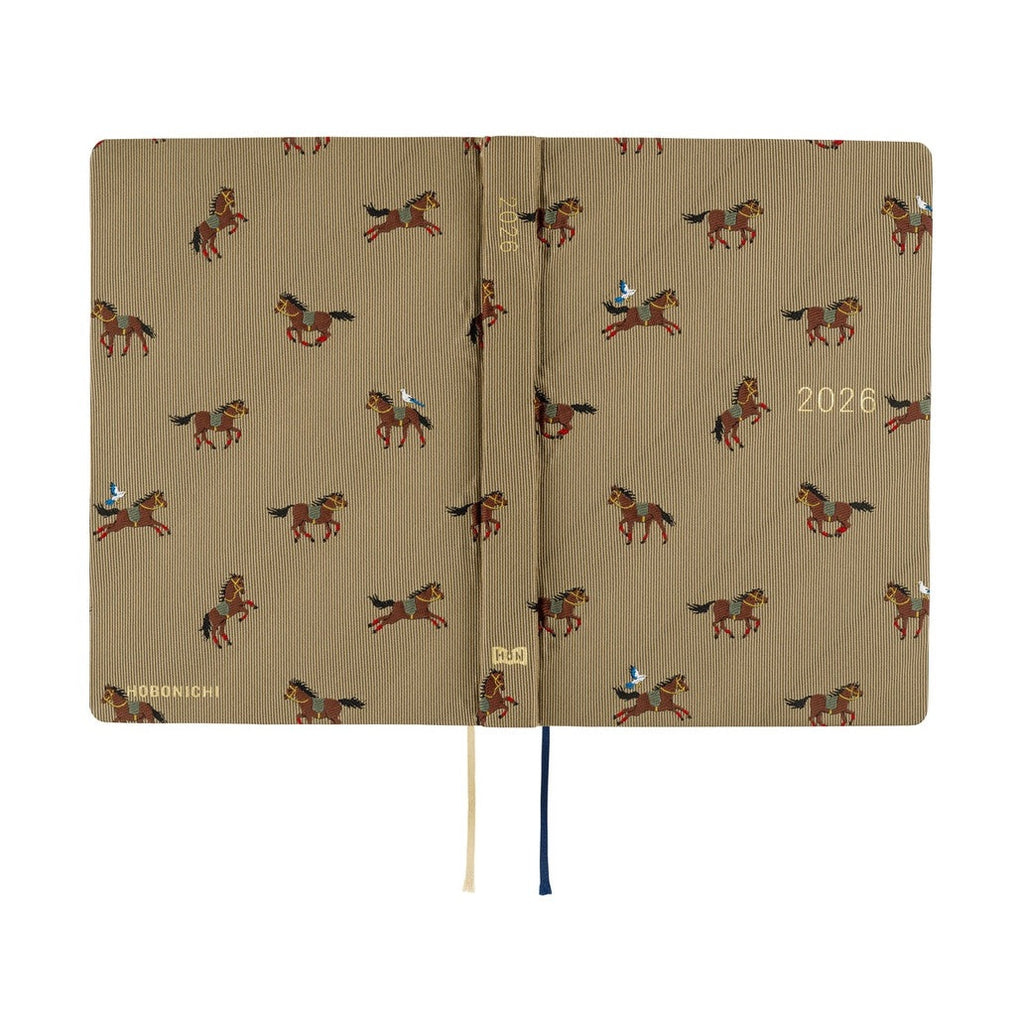 Open Hobonichi Techo 2026 A6 planner with grid pages and ribbon bookmarks