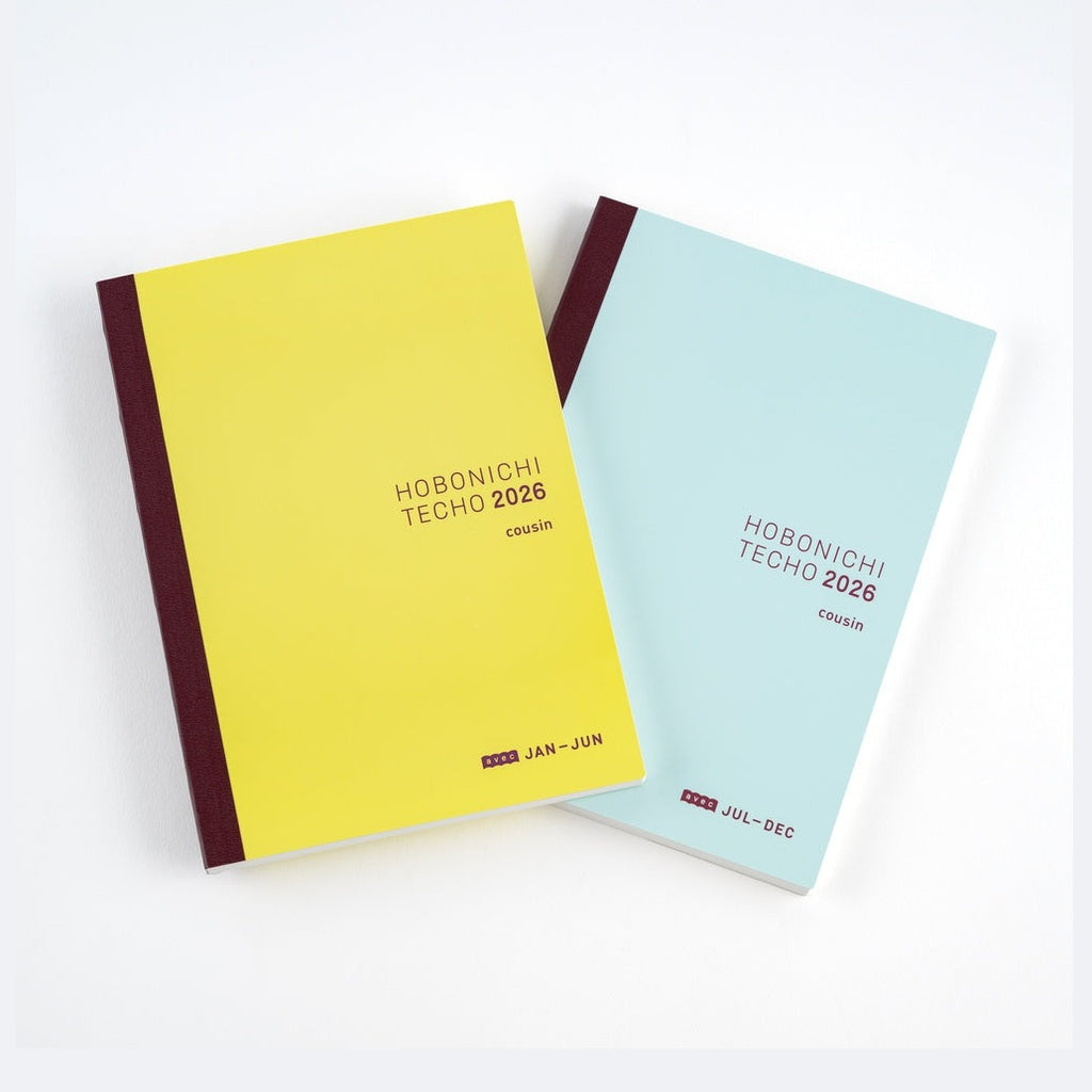 Yellow and blue Hobonichi Techo 2026 Cousin A5 diaries angled to show matte covers and spine text