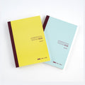 Yellow and blue Hobonichi Techo 2026 Cousin A5 diaries angled to show matte covers and spine text