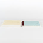 Cream and light blue Hobonichi Techo 2026 Cousin A5 notebooks side by side showing textured fabric covers