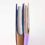Tan and lavender Hobonichi Techo 2026 Cousin A5 notebooks displaying stitched binding and inner page alignment