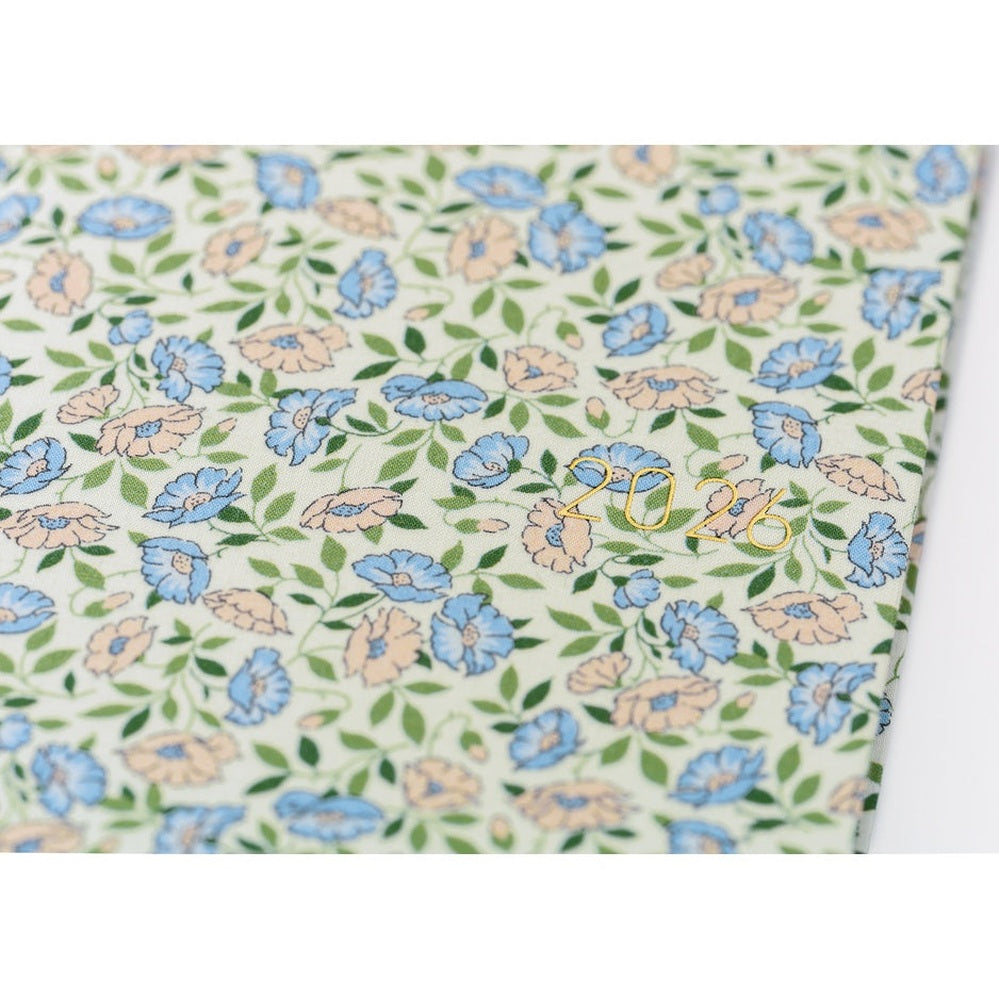 Close-up of gold foil 2026 stamp on Liberty Sasha Kiora floral hardcover diary texture detail