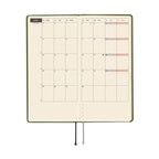Open Hobonichi Techo 2026 weekly planner with color-coded weekend cells and flexible spine design