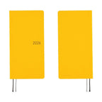 Two Hobonichi Techo 2026 Weeks MEGA diaries in yellow showing embossed details and ribbons