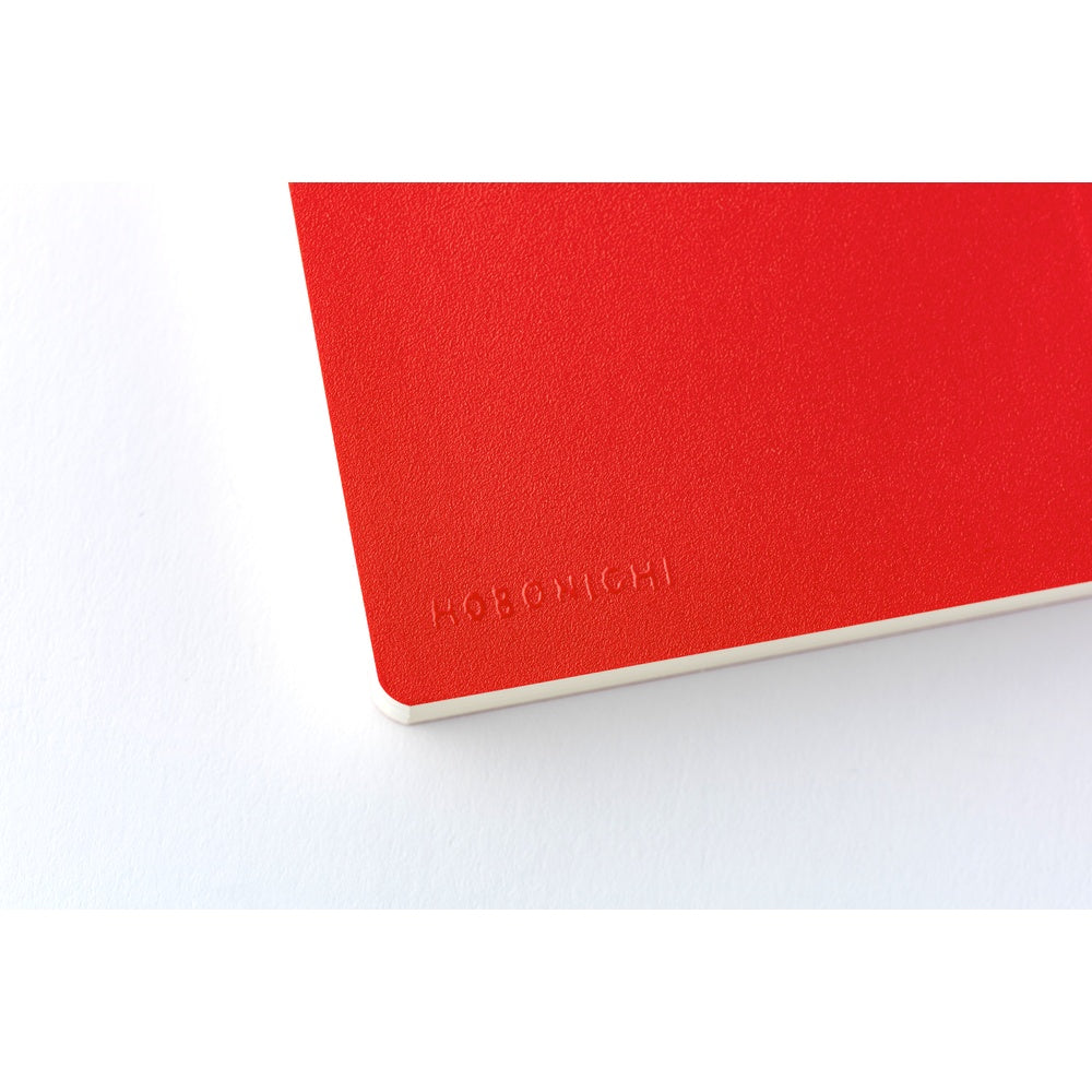 Embossed HOBONICHI brand name detail on textured tomato red diary cover corner