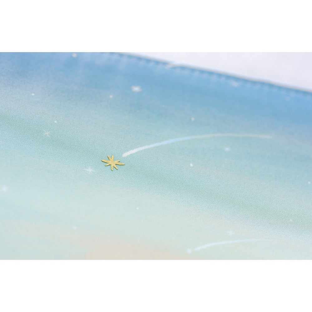 Close-up of textured polyester Hobonichi Techo cover showing gold star embellishment and shooting star details