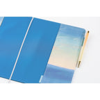 A5 Hobonichi Techo cover with vertical pocket sunrise seascape and beige pen for size reference
