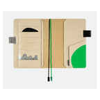 Closed Hobonichi Techo A5 cover with magnetic tab, clasp, and green wavy bookmark