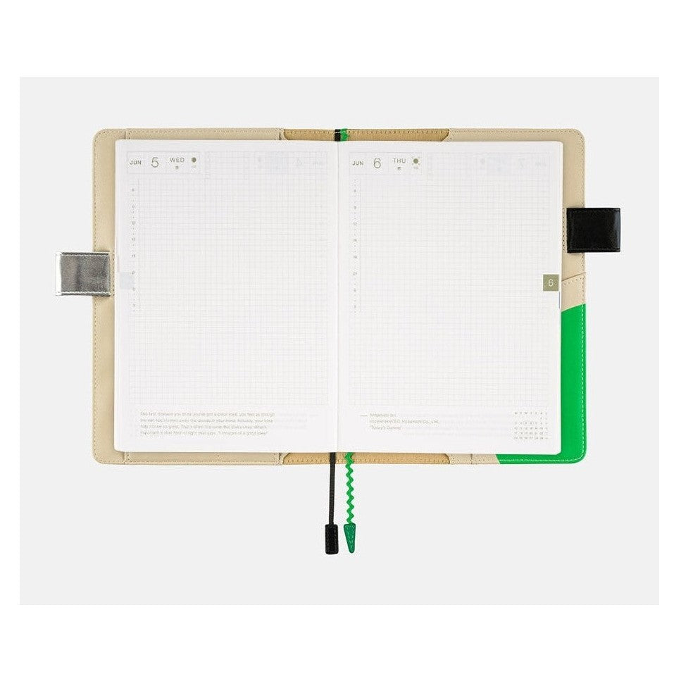 Open Hobonichi Techo A5 cover with June date layouts and green vertical strips