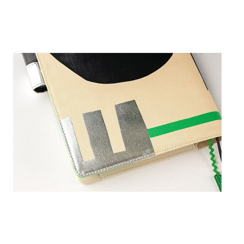 Close-up of silver foil design on textured cotton Hobonichi Techo A5 cover edge