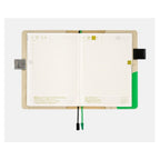 Open Hobonichi Techo A5 Cousins Pamm cover showing grid pages and interior pockets