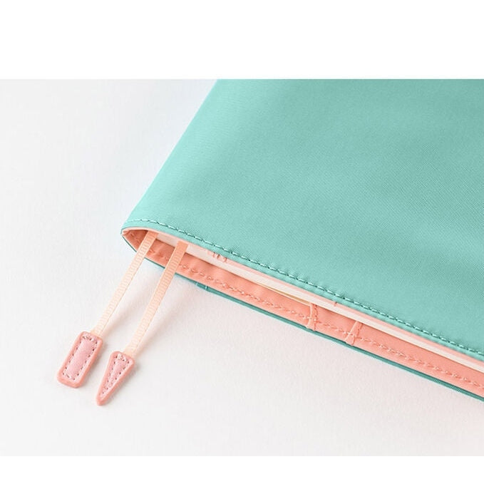 Close-up of Dreamy Soda Hobonichi A5 cover corner with peach lining and ribbon ties