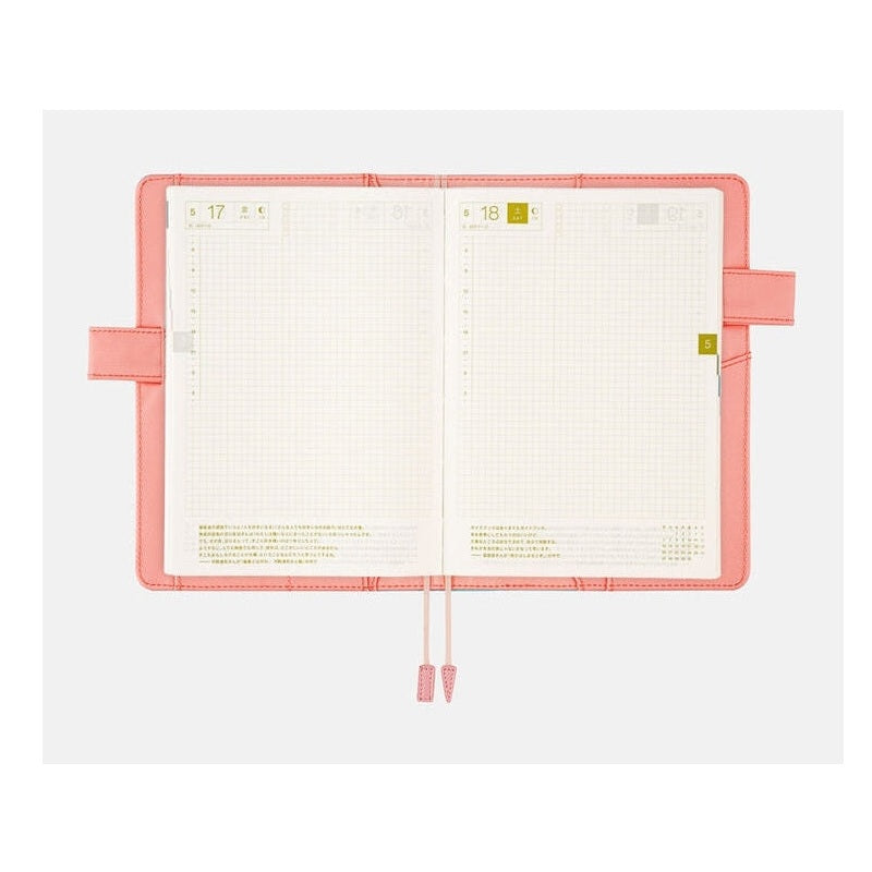 Open Dreamy Soda Hobonichi A5 planner showing grid pages and pink ribbon ties