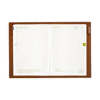 Open Hobonichi Techo A5 planner inside brown leather cover with grid pages