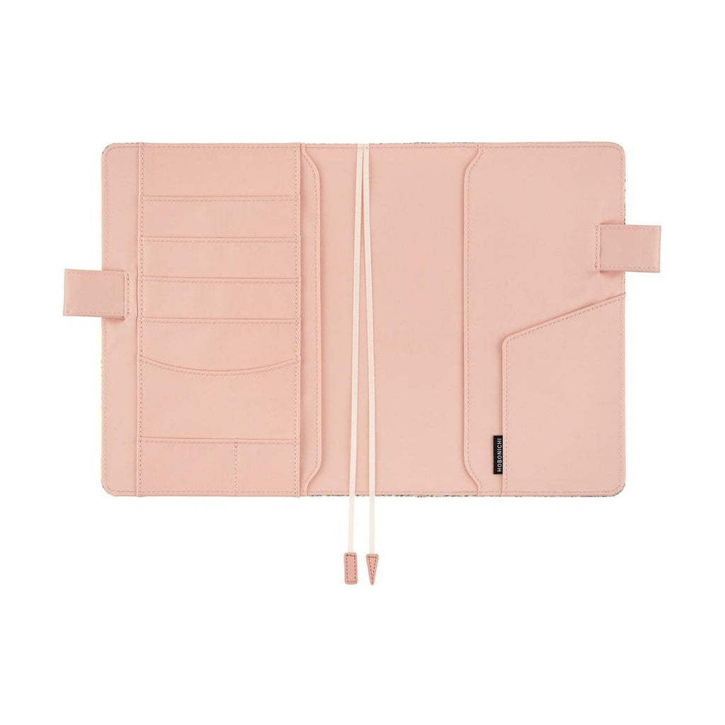 Interior view of cotton-blend planner cover with pale pink lining and storage pockets