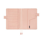 Interior view of cotton-blend planner cover with pale pink lining and storage pockets