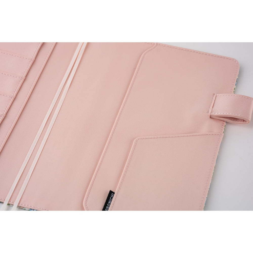 Close-up of MINIMARU tag on vertical pocket inside floral planner cover
