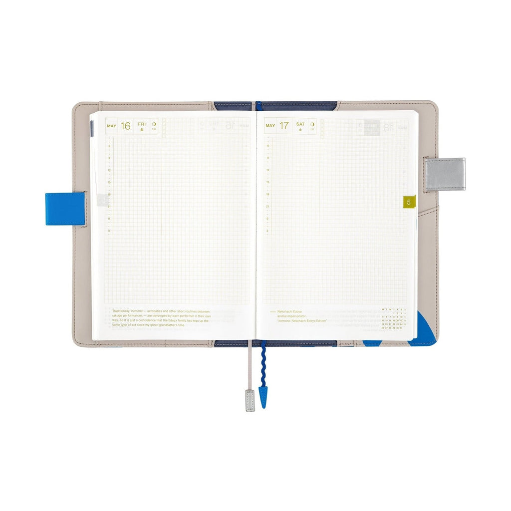 Hobonichi Techo A5 planner open showing May dates, grid pages, and blue wavy sea design